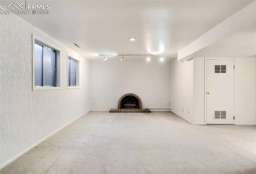 Basement rec room with a gas fireplace