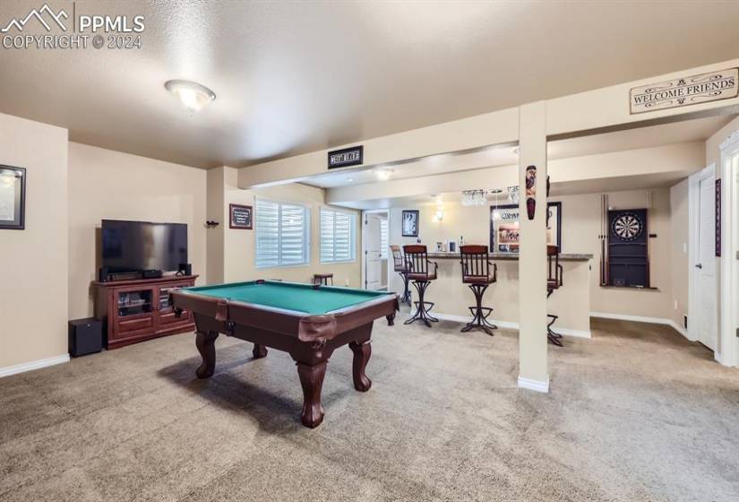 Basement family room featuring wet bar and pool table