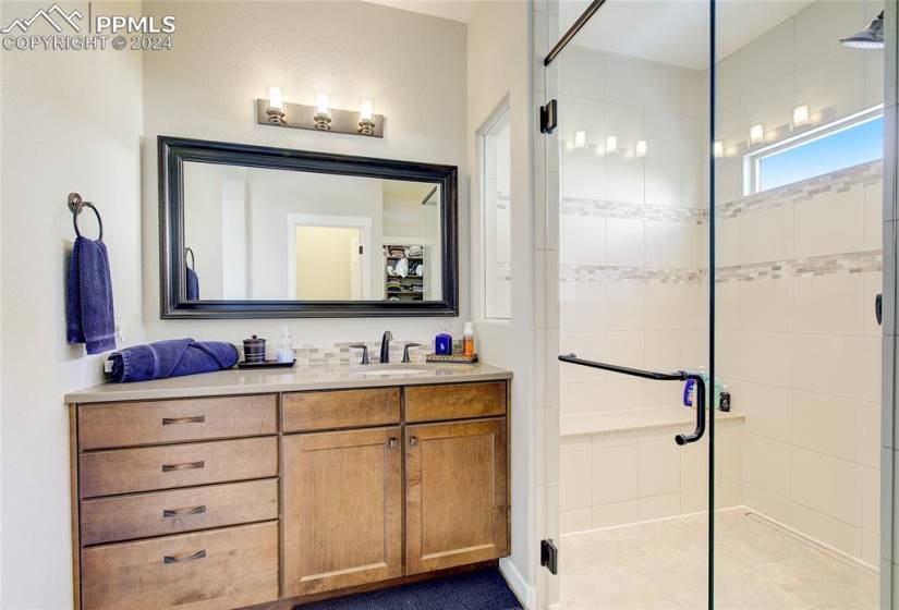 Bathroom featuring an enclosed shower and vanity