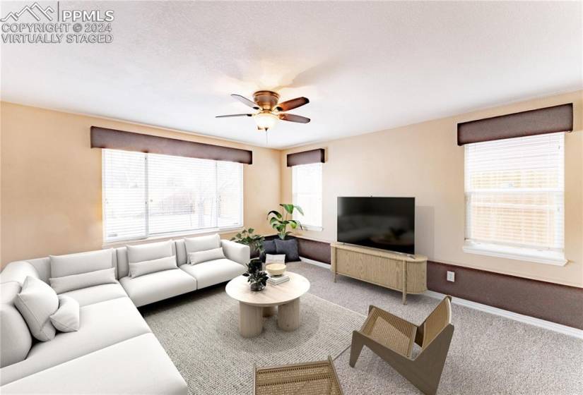 *Virtually Staged* Living room with a wealth of natural light, ceiling fan, and new carpet