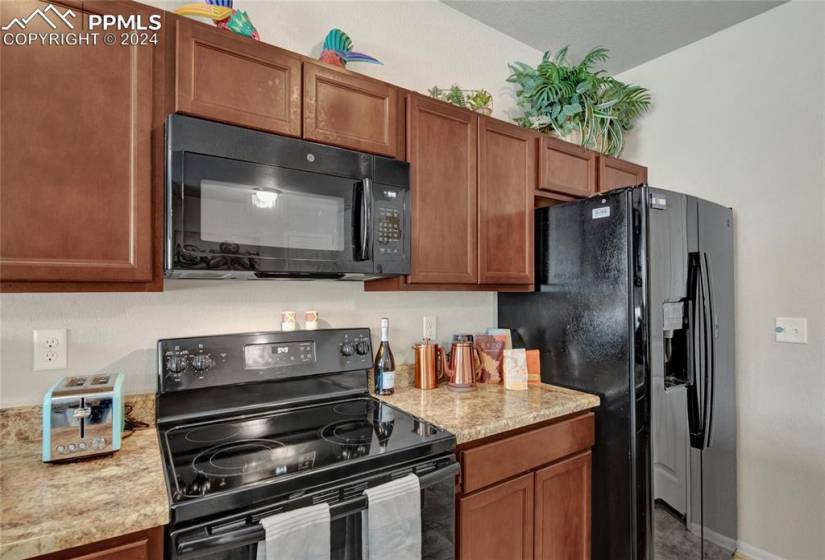 Kitchen with included refrigerator, smooth top stove, microwave