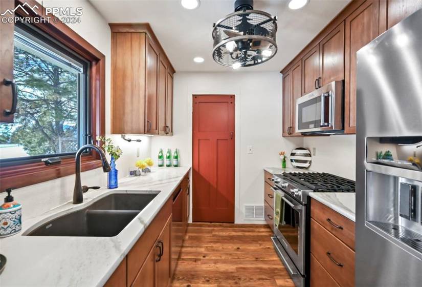 Renovated kitchen with dovetail, soft close Pecan cabinets featuring pullouts, stainless steel including gas stovetop and MORE!
