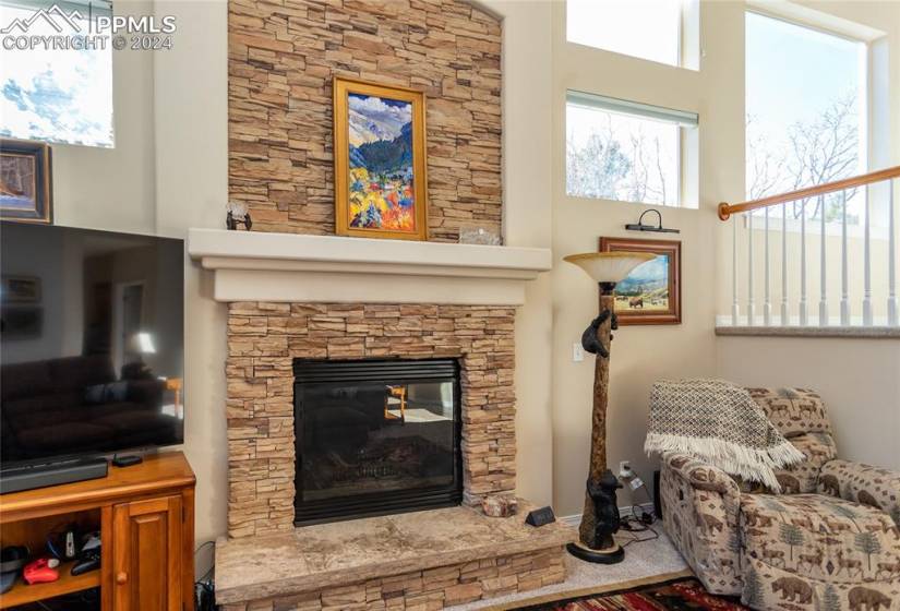 Living room featuring a stone fireplace