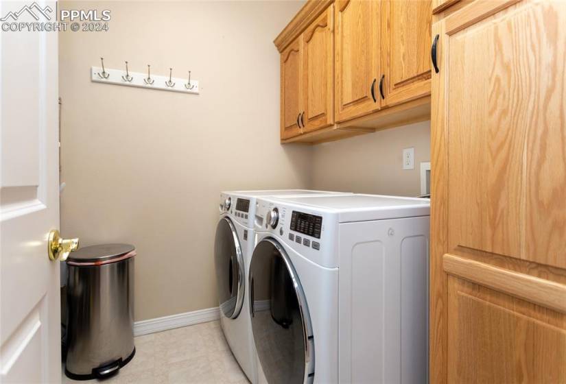Laundry room on the main level with cabinets, washing machine and dryer are included
