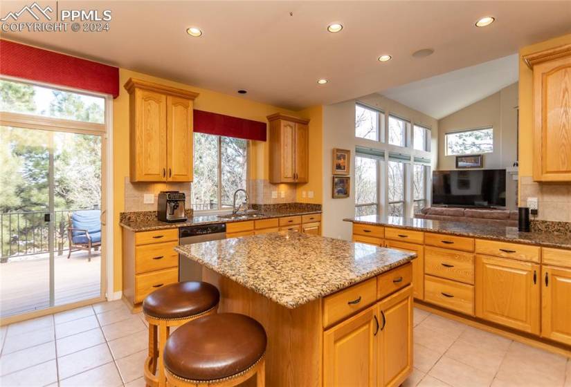 Kitchen featuring a wealth of natural light, light tile floors, and backsplash