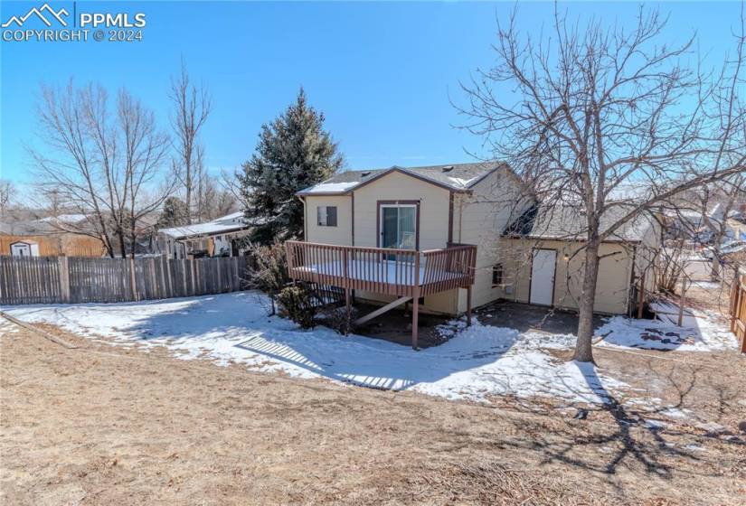 Snow covered house with a wooden deck