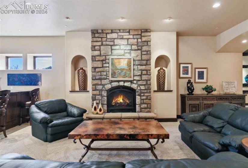 Living room with a fireplace and light colored carpet