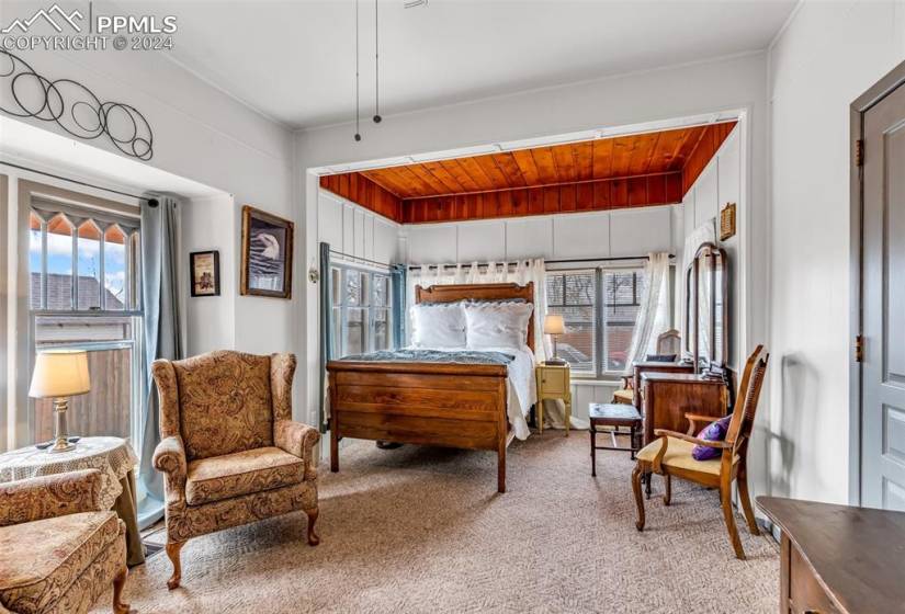 Carpeted bedroom with wooden ceiling