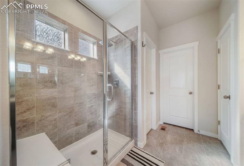 Primary Bathroom featuring an enclosed shower and tile floors