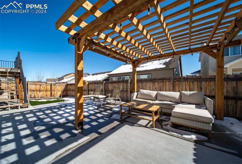 View of patio featuring an outdoor living space and a pergola