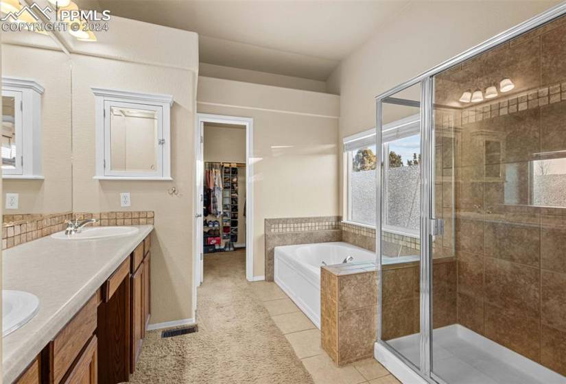 Bathroom with tile floors, plus walk in shower, and double sink vanity