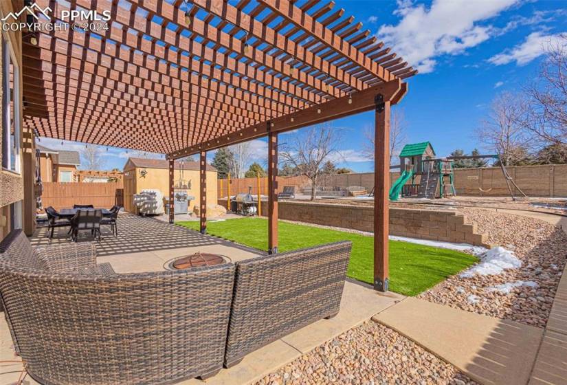 View of patio / terrace featuring a playground and a pergola
