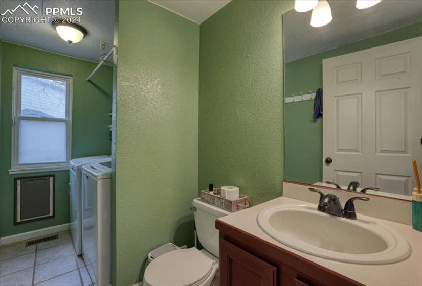 Main Level Powder Bathroom for guests and Laundry Room w/ washer and dryer that stay.
