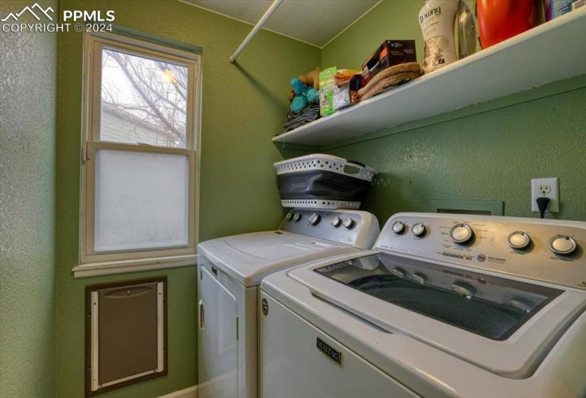 Laundry Room with built-in shelf and washer and dryer that stay.