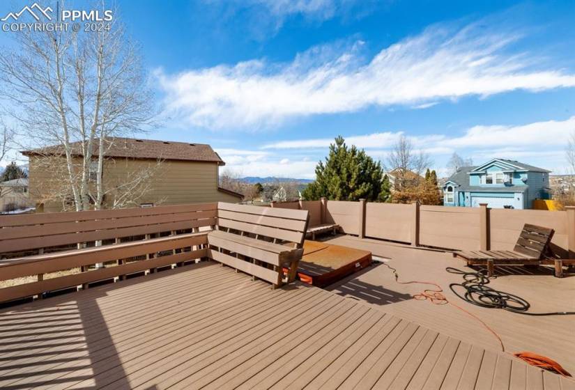 Composite deck with built-in seating and hot tub.