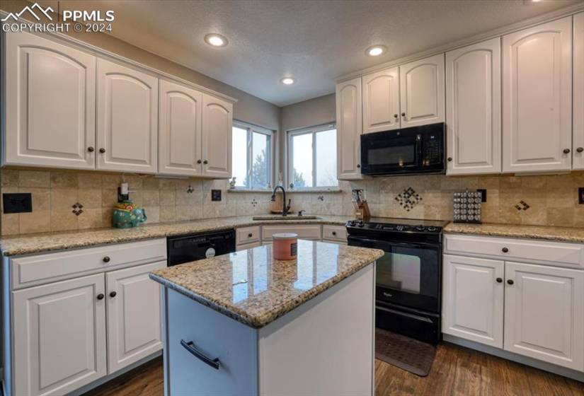Appliances include a dishwasher, smooth top range oven, built in microwave, and French door refrigerator.