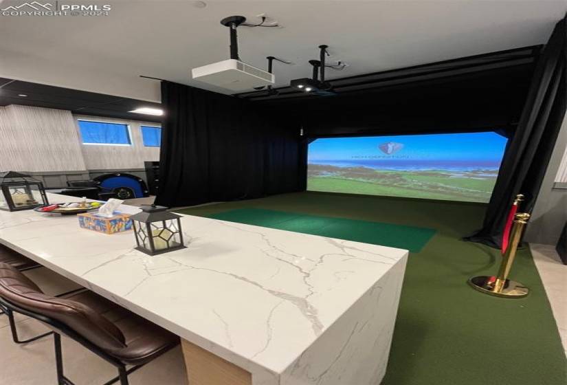 Playroom featuring golf simulator