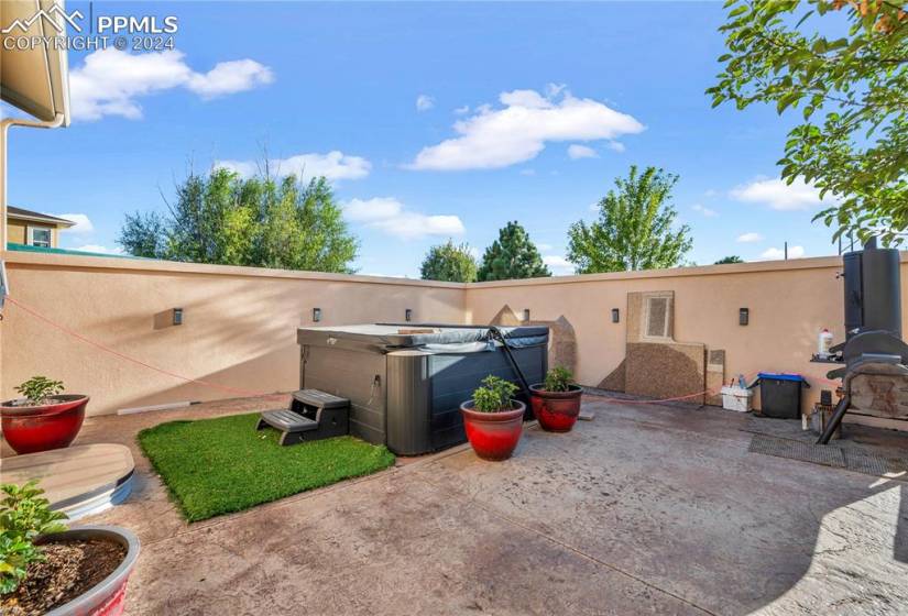 This walled area off the patio provides shelter and privacy (hot tub not included)