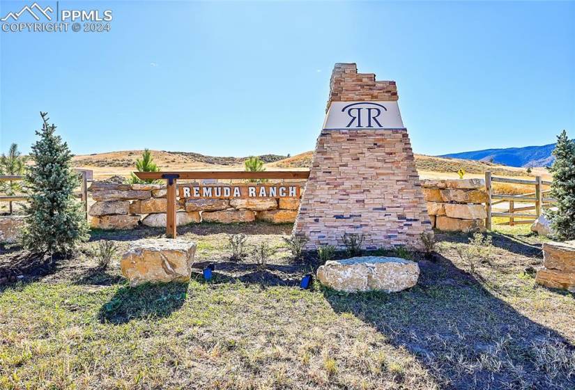 Community sign with a mountain view