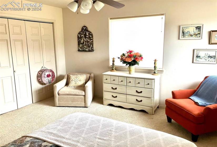 Sitting room featuring ceiling fan and light carpet