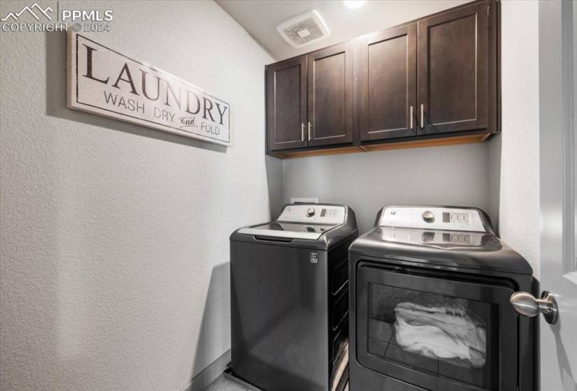 Basement Laundry Room  with upper cabinets.