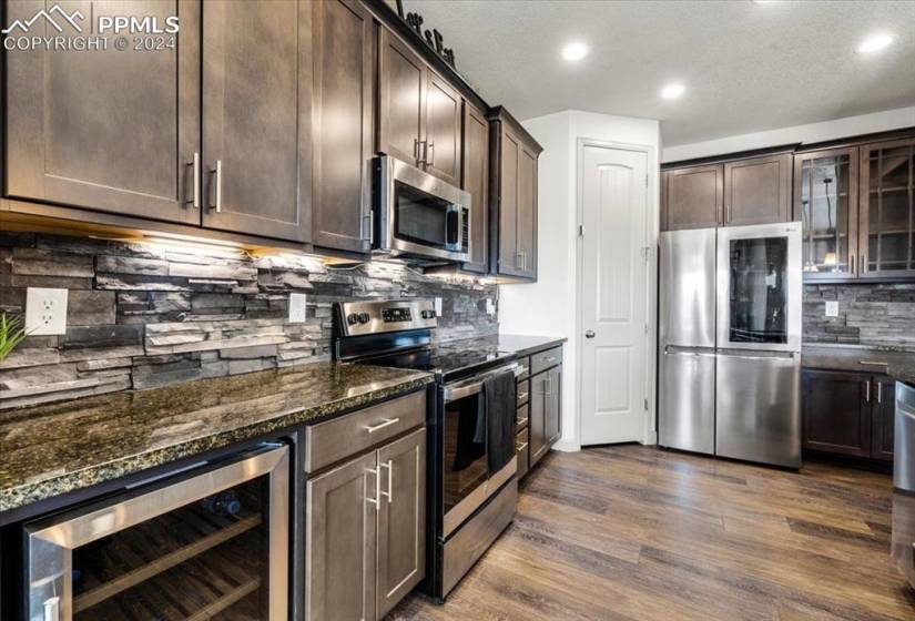 Stainless steel appliances include a SMART refrigerator, smooth top range oven, built-in microwave, dishwasher, and wine fridge.