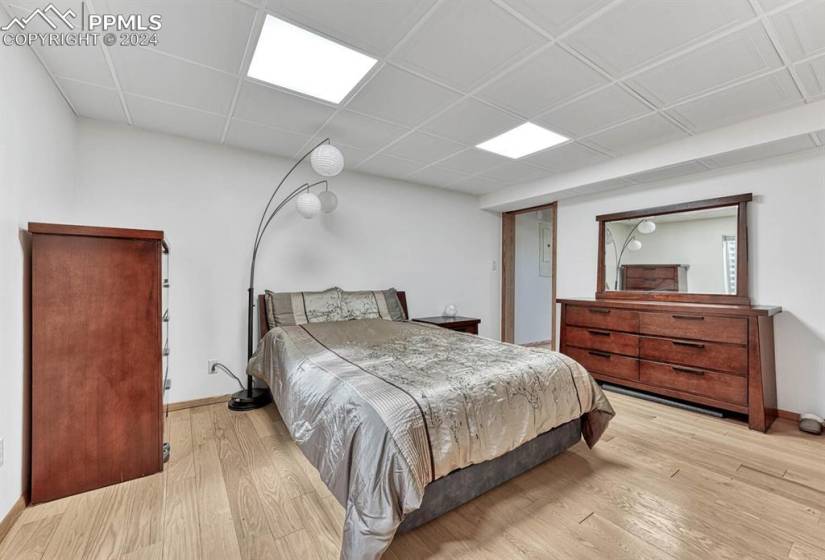 Bedroom #4 with light hardwood / wood-style flooring and a paneled ceiling