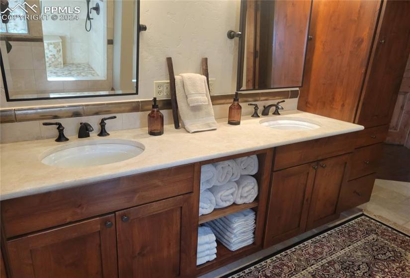 Bathroom featuring double vanity and lots of cabinet storage
