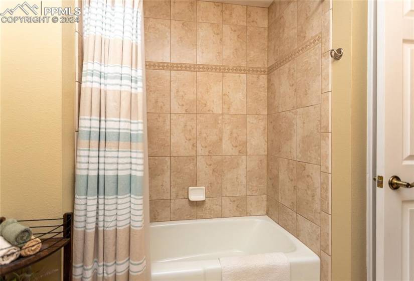 Upper Level Bathroom has Tile Floor and Stone counters