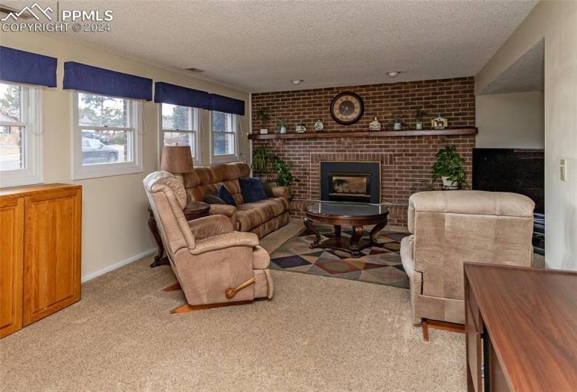 Family Room with Gas fired, brick Fireplace and adjoining bonus Room