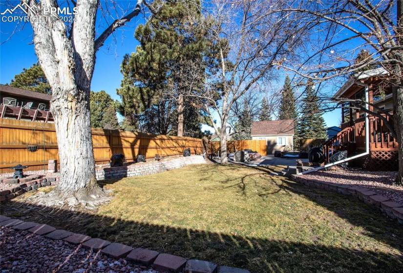 Very Private, fully-fenced Yard with Deck, Patio, Storage Shed and lots of mature trees