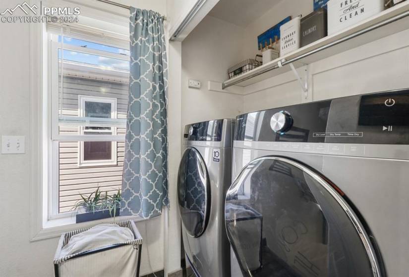 Clothes washing area with a healthy amount of sunlight and washing machine and dryer