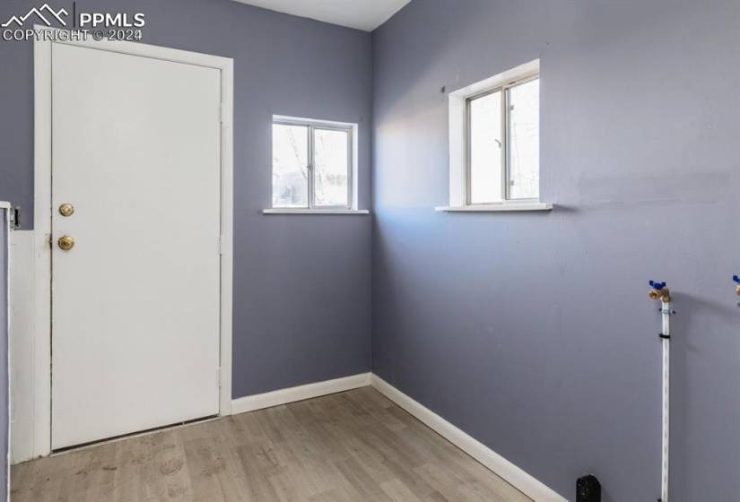 Laundry room with plenty of natural light and light hardwood / wood-style floors