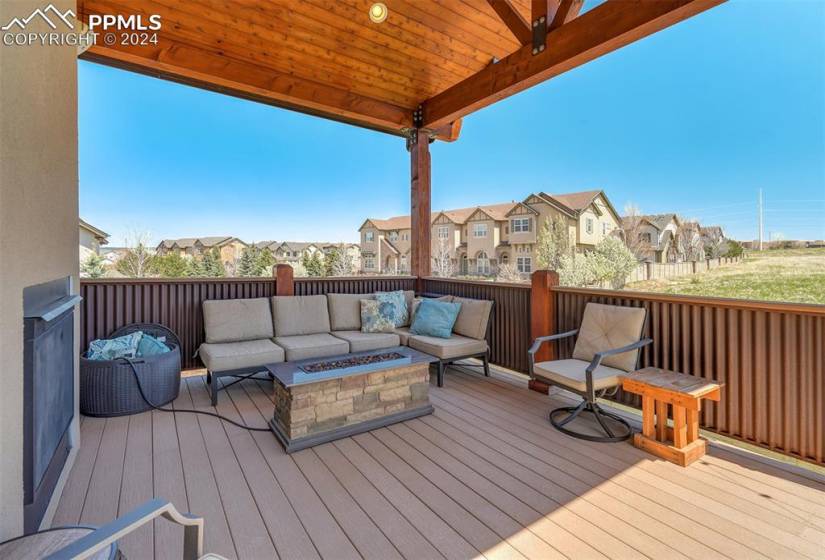 Deck with an outdoor living space with a fire pit