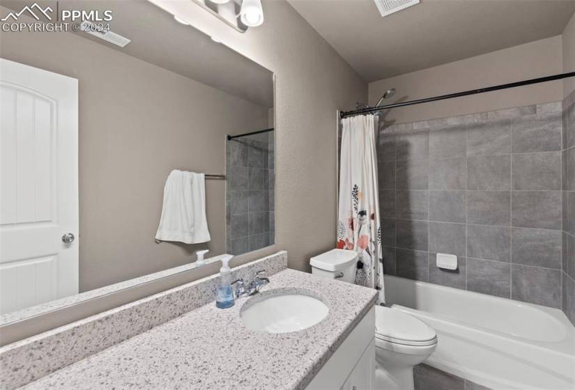Full upper bathroom with granite counter