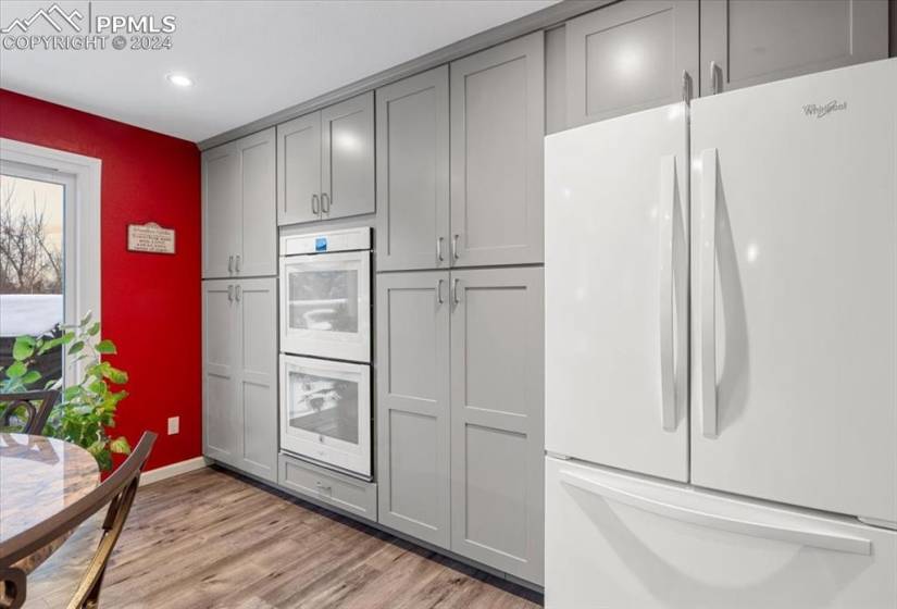Bright and clean appliances add functional punch to this wall of storage.