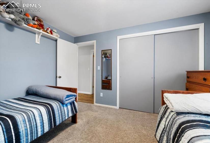 This bedroom is bright and spacious and is at the end of the hallway across from a full bath.