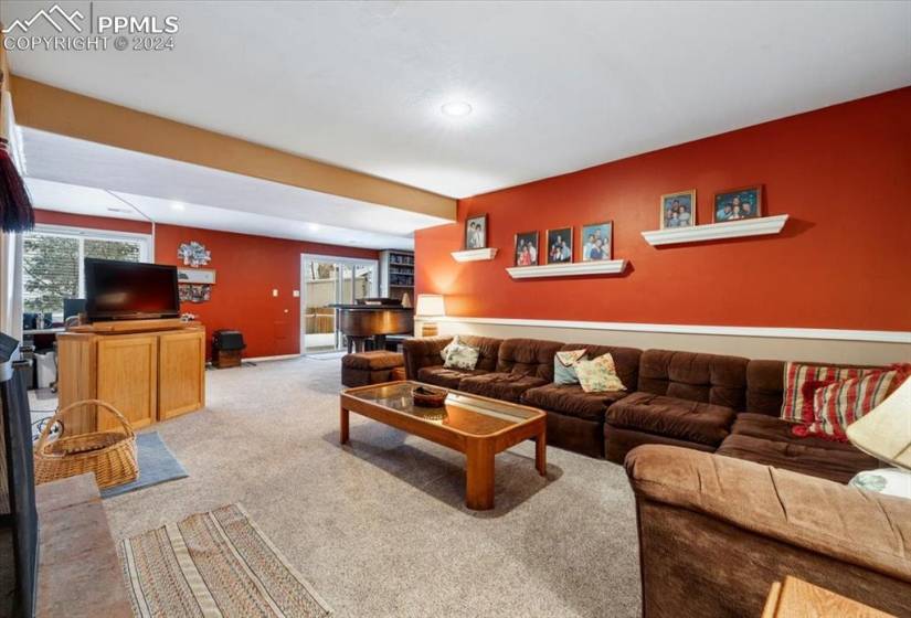 The basement-level family room is filled with warmth and light.