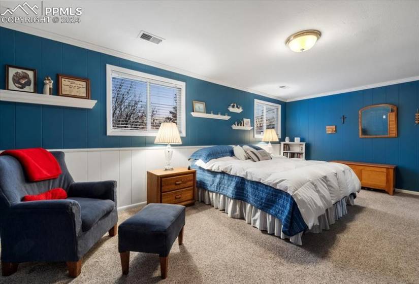 Paneled walls and cerulean blue paint make this bedroom a relaxing retreat.