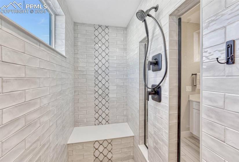 Bathroom with vanity and tiled shower