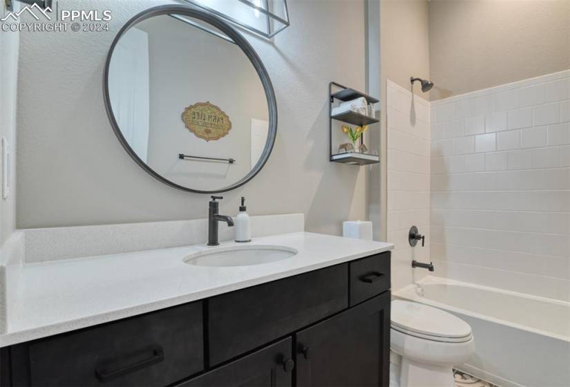 Full bathroom with shower / bathtub combination, toilet, and vanity