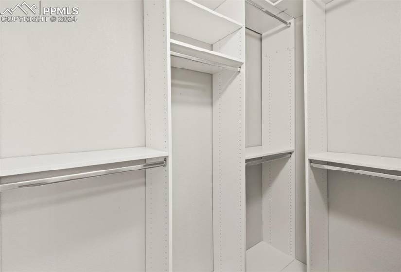 View of spacious primary walk-in closet