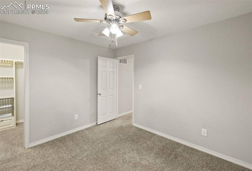 Bedroom #2  with light carpet and ceiling fan