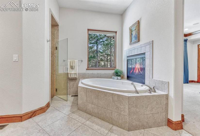 Bathroom featuring  a private walk in shower, tile floors and huge jetted tub