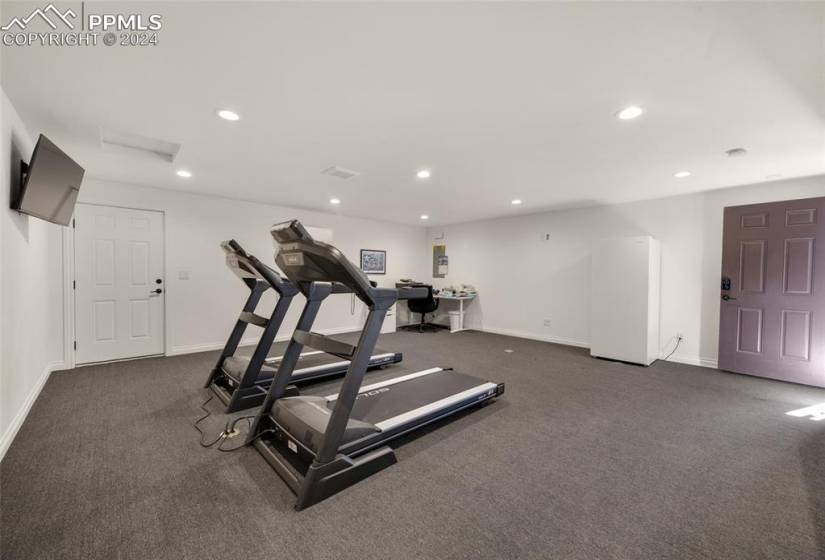 Workout room with dark colored carpet
