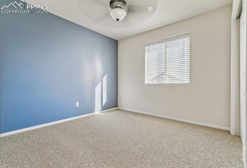 Bedrooms featuring ceiling fan and light colored carpet