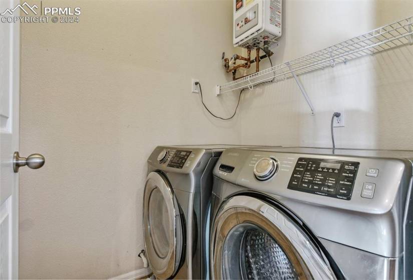 Laundry room with washer and dryer and water heater