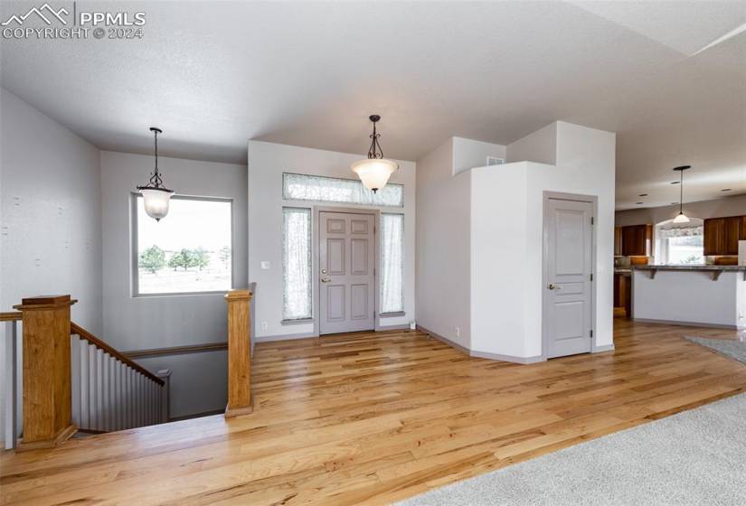 Bright Foyer entrance with closet and extensive main level wood flooring.