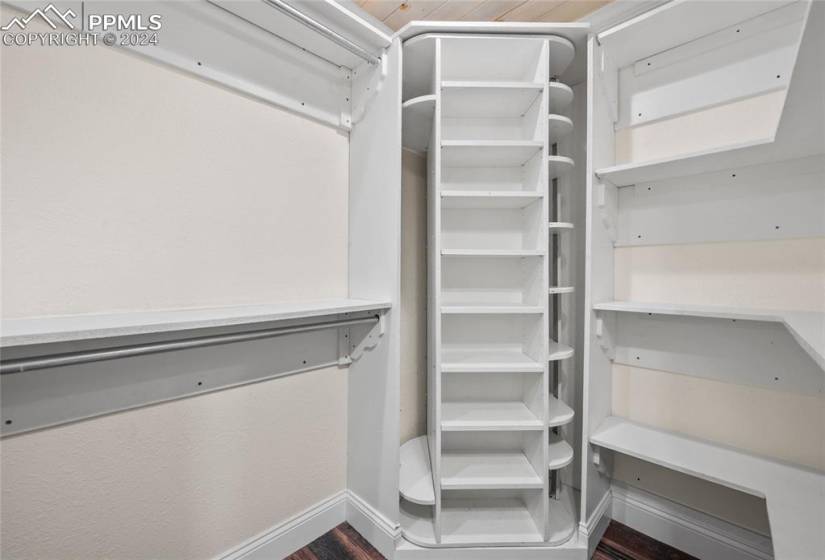 Primary Bedroom Walk in closet with built-in rotating shelving