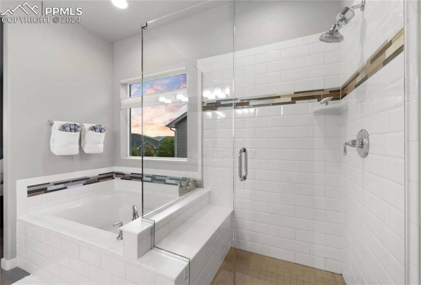 Bathroom featuring tile walls, separate shower and tub, and tile floors